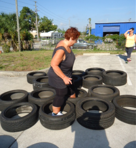 Sharon completing her daily workout includes running through tires